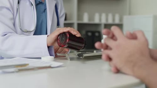 Doctor Preparing Pills for Patient in Office