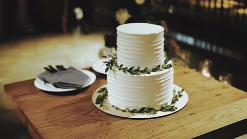 White Wedding Cake with Green Leaf Decorations