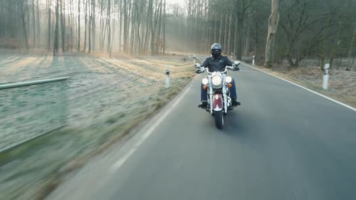 Motorcycle Rider on Rural Road at Sunrise