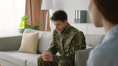Troubled Man in Camouflage Uniform Talking with Therapist