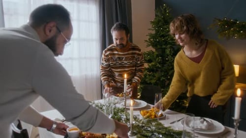 People Setting a Festive Holiday Dinner Table