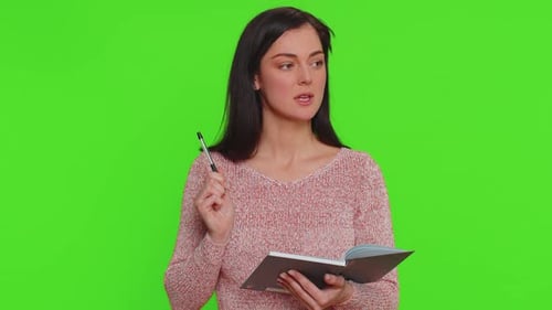 Woman Writing in Notebook on Green Screen