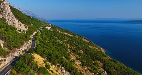 Aerial view following a mountain road on the Makarska riviera in sunny Croatia