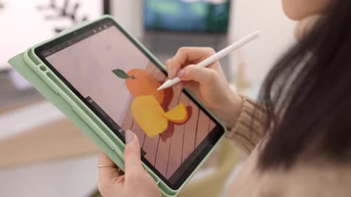 Young Adult Drawing Digital Art on Tablet