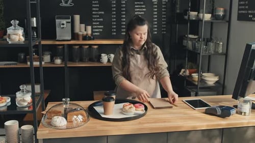 Woman With Disability Working In Cafe
