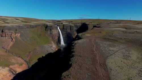 Haifoss Waterfall Flowing Down To The Valley In Iceland During Summer. - aerial shot