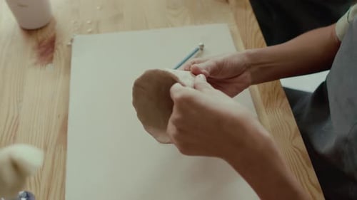 Close-up of Unrecognisable Female Potter Shaping Clay into Cup