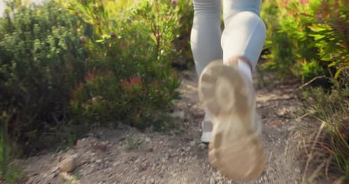 Running, fitness and feet of person on path for exercise, workout and performance from the back