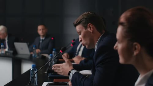 Speech Of Political Speaker At Meeting Room Of Modern Business Center. Adult Man In Suit Explains...