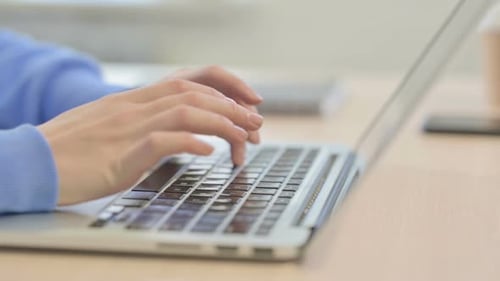 Side View of Woman Typing on Laptop, Close up