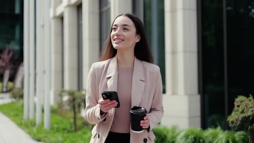Business Woman Walking with Phone and Coffee