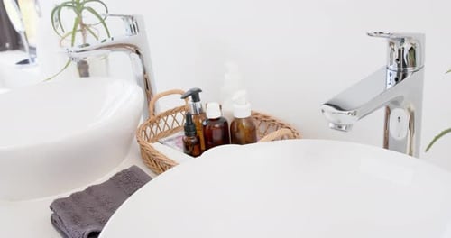 Close up of washbasin and accesories in bathroom, slow motion