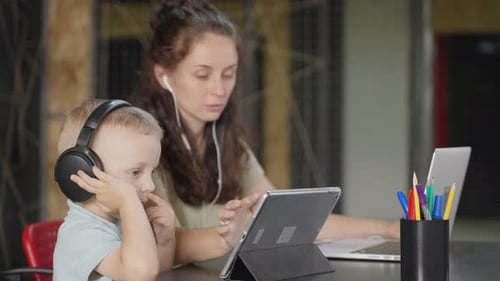 Woman and Child Using Technology at Home