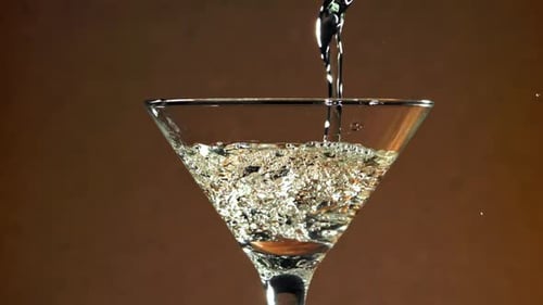 Clear Liquid Poured into Martini Glass Close Up