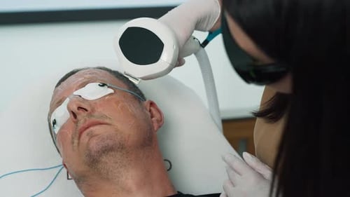 Man Receives Laser Facial Treatment in Medical Clinic