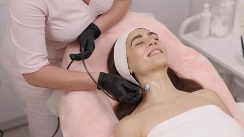 Young Adult Receiving Facial Treatment at a Medical Spa