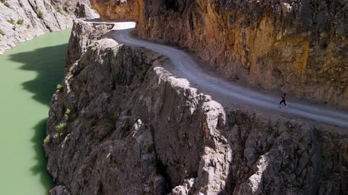 Female Athlete Running in Canyon