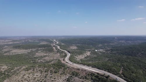 High angle view of cars driving through the Texas Hill Country along the Devil's Backbone