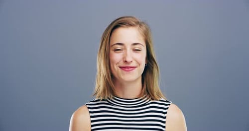Young Woman Giving Thumbs Up to Camera