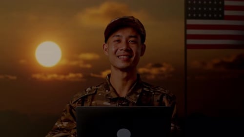 Close Up Of Asian Man Soldier Using A Laptop And Smiling With Flag Of The United States