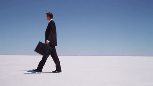 Businessman Walking with Briefcase at Salt Flat 25-30