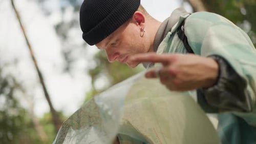 Adventurer Determines Route with Determined Expression Outdoors Hiker Selects Trail Path Confidently