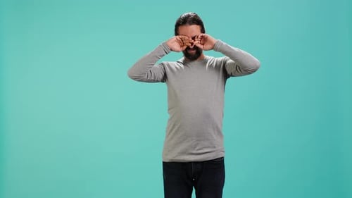 Man Feeling Exhausted From Overworking and Lack of Sleep Rubbing Eyes