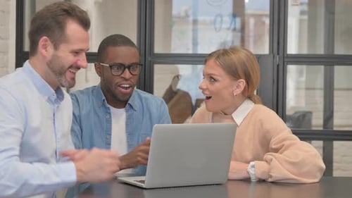 Excited Business People Celebrating Success in Office