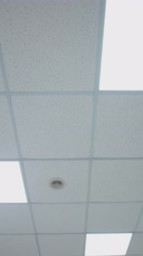 Corridor ceiling with light. Lamps on ceiling in hospital corridor. Bottom view. Vertical video