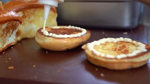 Creamy Sauce Applied to Toasted Burger Buns