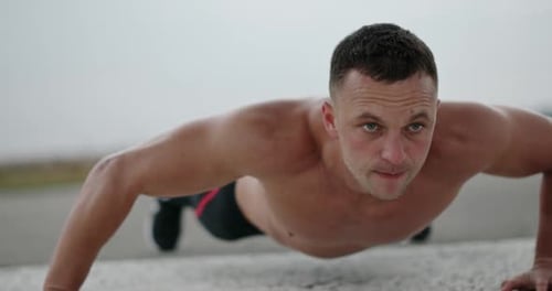 Muscular Man Doing Push-ups Outside
