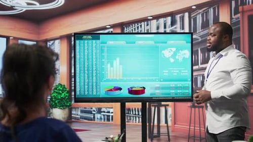 Man Presenting Financial Data in Workplace