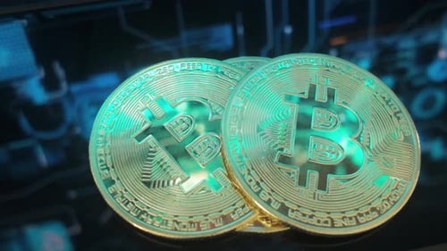 Gold Bitcoin Coins on Dark Surface Close Up