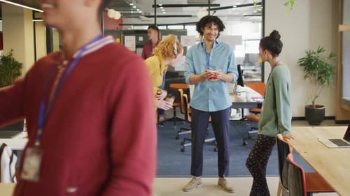 Happy diverse business people discussing work during meeting at office
