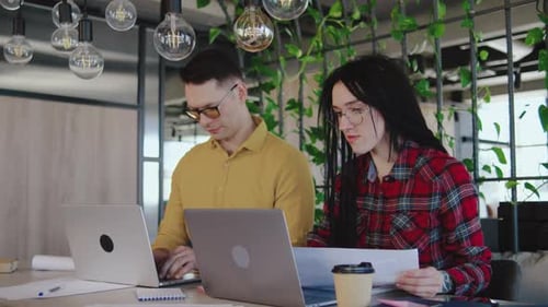 Colleagues Working on Laptops Celebrate Success
