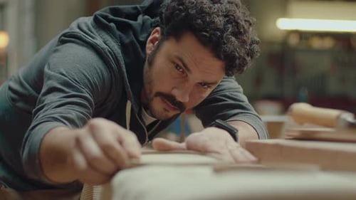 Artisan Checking Wooden Tray after Polishing in Workshop