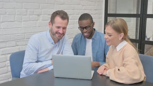 Three Colleagues Waving During Video Conference on Laptop