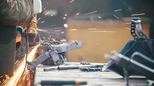 Industrial Concept A Man Worker Cutting a Black Chain