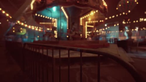 Empty Amusement Park at Night with Glowing Lights and Deserted Rides