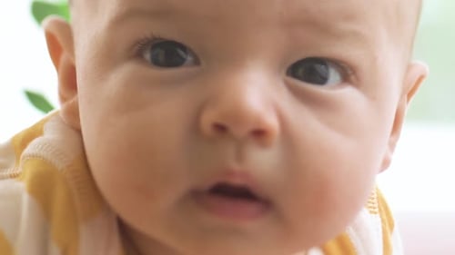 Newborn Little Baby Lying on the Bed and Smiling
