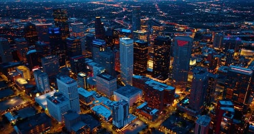 Luminous streets of modern Houston, Texas, USA. Drone flight above the high-rise downtown
