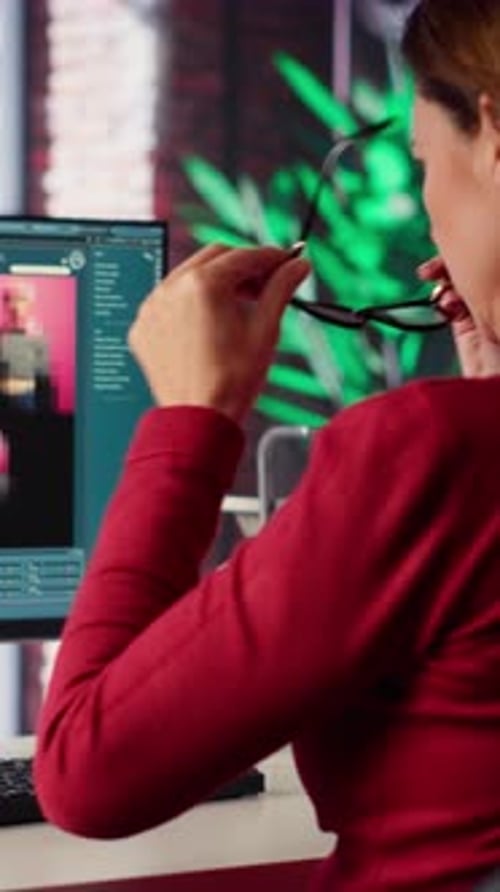 Woman Editing at Computer in Modern Office