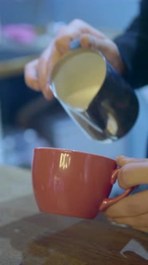 Cream Poured Into Latte Cup Creating Leaf Design