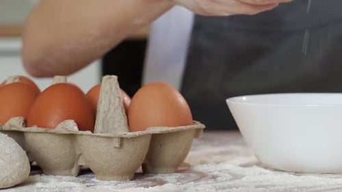 Cracking Eggs into a Bowl for Baking