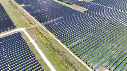 Aerial View of Big Sustainable Electric Power Plant with Many Rows of Solar Photovoltaic Panels for