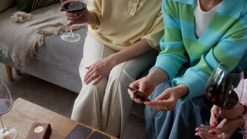Mature Friends Fortunetelling in Living Room