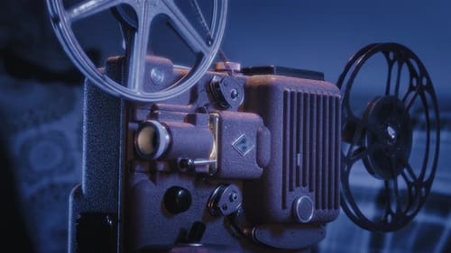Vintage Film Projector Running in Dark Environment