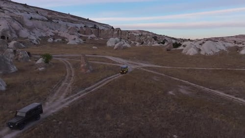 Aerial view of rugged rocks and road at sunset, Turkey.