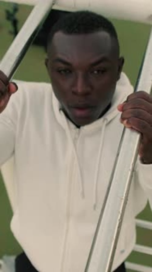 Top view of a man doing pull-ups on a horizontal bar