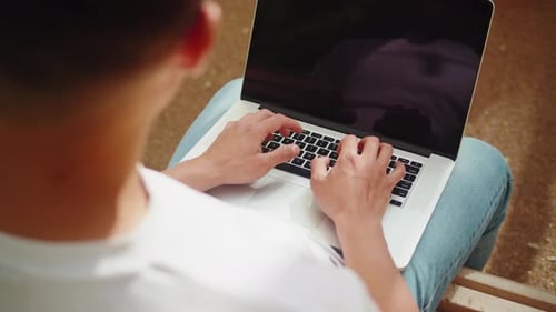 Asian Man Using Laptop Outdoor Closeup